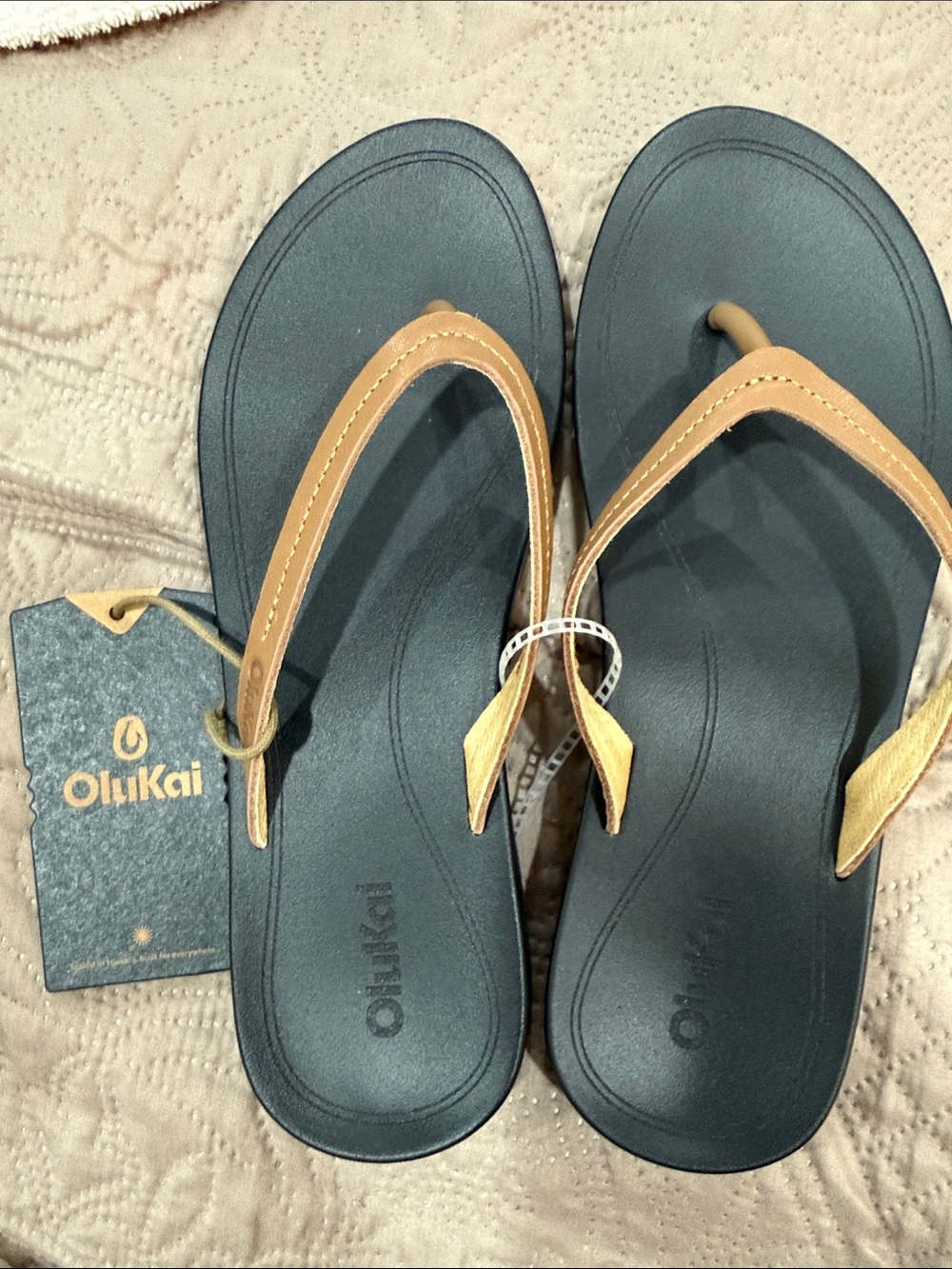 OluKai Women's Black and Tan Strappy Flip Flop Sandals